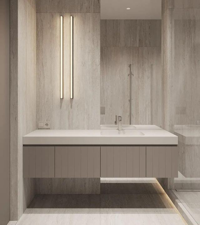 Pale stone top with integrated basin over fluted fronts