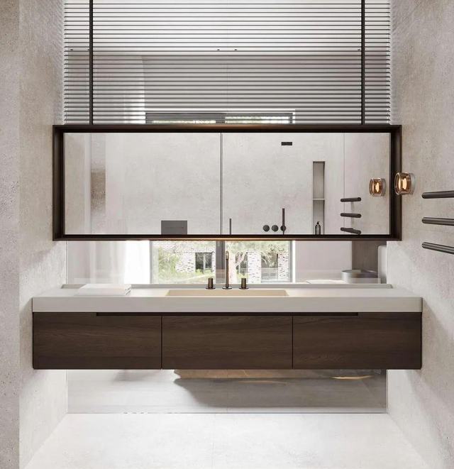 Walnut vanity under a window with a hung mirror