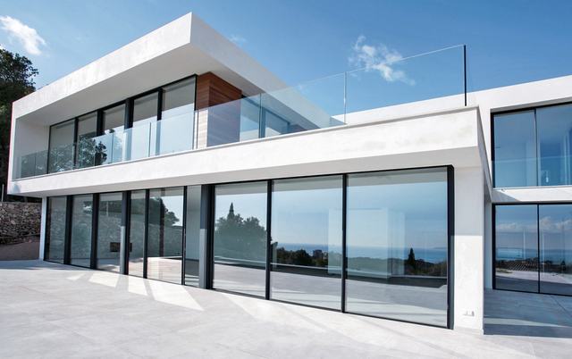 Slim-frame sliding glass along a white modern house