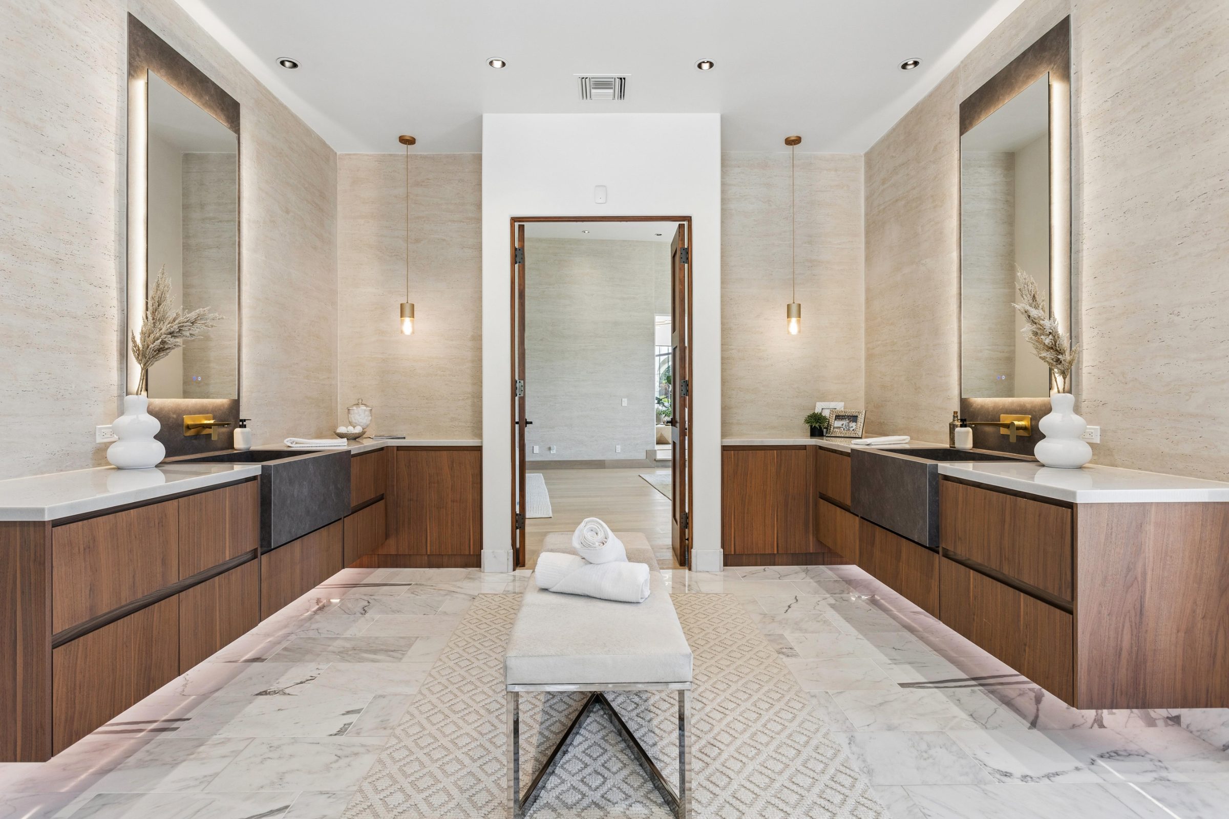 Primary bath with twin walnut vanities and MCM stone backsplash walls, Paradise Valley